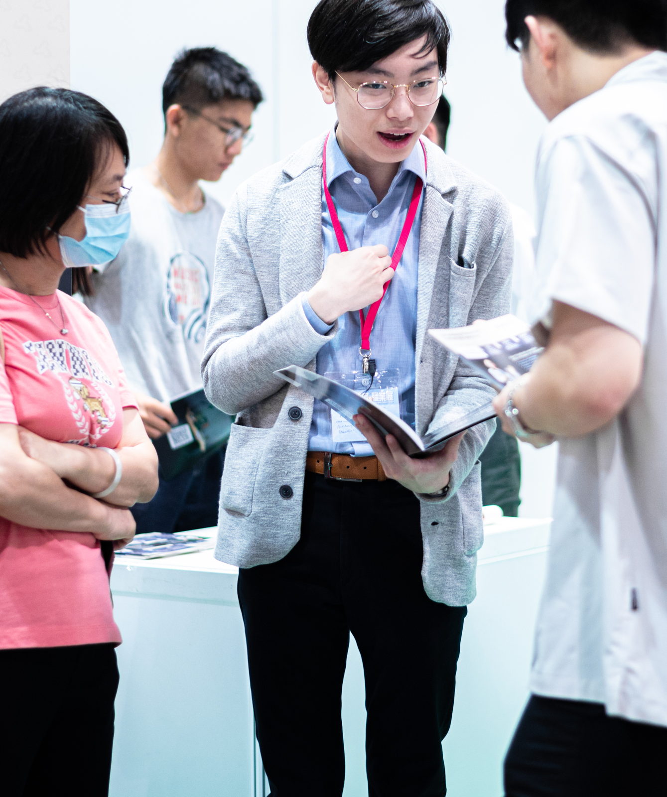 One of the team talking a parent and student through an open course brochure at the expo stand.